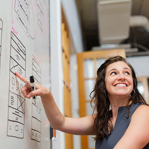 alex at whiteboard working on wireframes