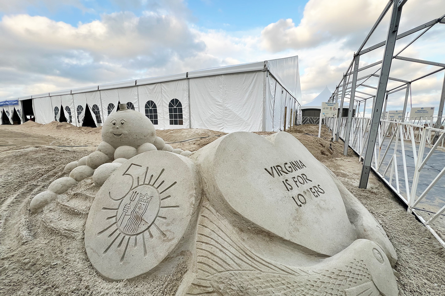 50th logo sculpted in sand